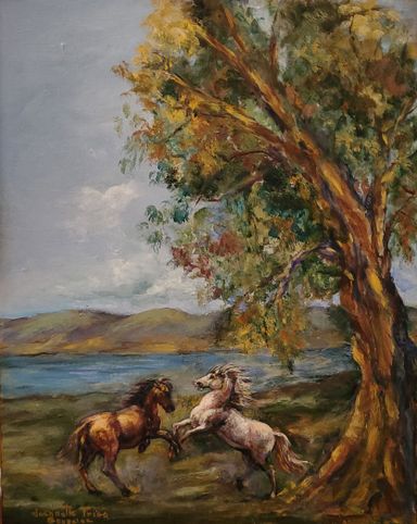 Two horses playing by an old tree